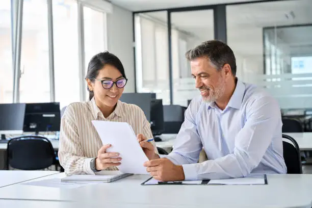 Contadoor accountant reviewing financial statements with a company director